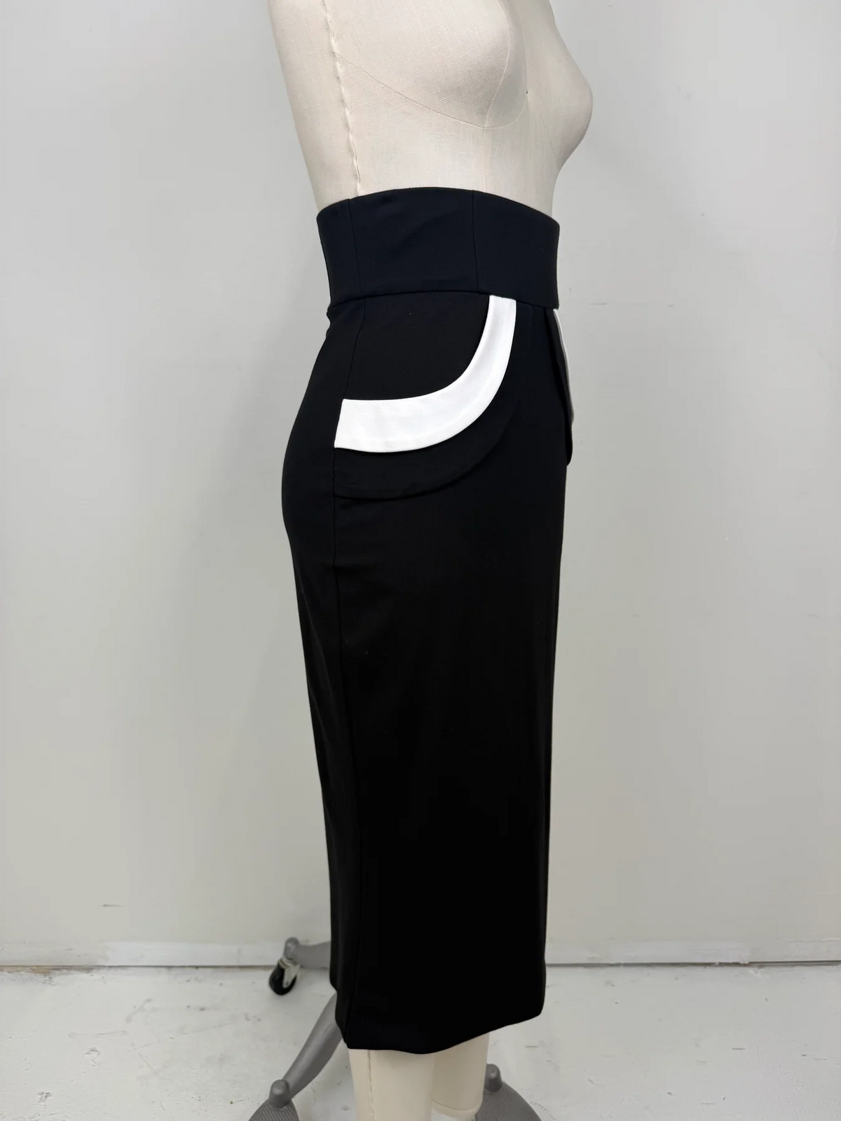 The Love Me Not Skirt is designed with a sleek, high waisted silhouette that flatters the figure while keeping the look polished and refined.