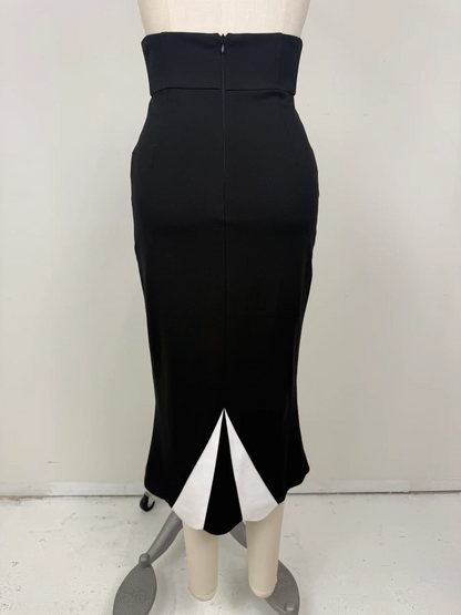 The Love Me Not Skirt is designed with a sleek, high waisted silhouette that flatters the figure while keeping the look polished and refined.