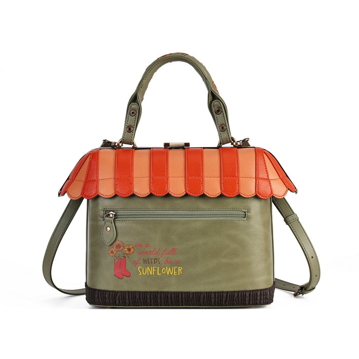 An olive green handbag with a decorative orange and peach scalloped roof detail, featuring a front zip pocket, top handles, and a shoulder strap. The front is embroidered with 'Dusty Rose and Sunflower' in pink and yellow text with a small rose graphic.
