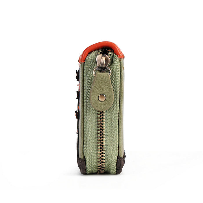 A close-up side view of a small zippered pouch or wallet in textured sage green fabric, featuring a bright orange-red top trim, a matching green leather tab with a metal snap, and a gold-tone zipper pull.