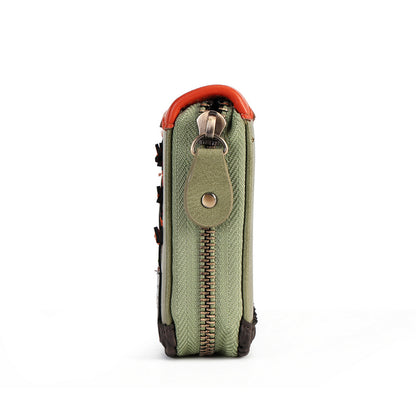A close-up side view of a small zippered pouch or wallet in textured sage green fabric, featuring a bright orange-red top trim, a matching green leather tab with a metal snap, and a gold-tone zipper pull.