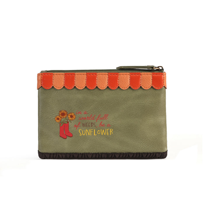 An olive green zippered pouch featuring a scalloped orange and red trim along the top, a dark brown ruffled bottom edge, and a graphic on the front with red boots, sunflowers, and the text 'in a world full of weeds, I am SUNFLOWER'.