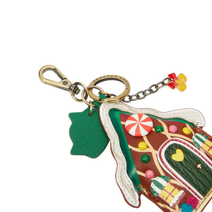 Colorful gingerbread house keychain with candy decorations on a white background