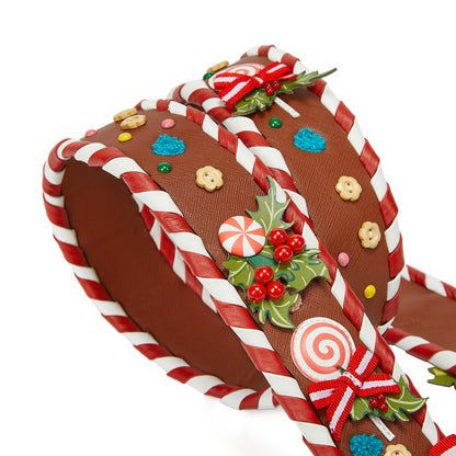 Decorative headband resembling a gingerbread house with candy cane details on a white background