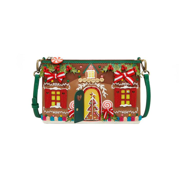 Gingerbread house-themed handbag with candy cane accents on a white background