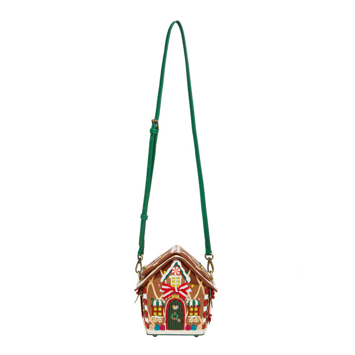 Gingerbread house-shaped handbag with a green strap on a white background