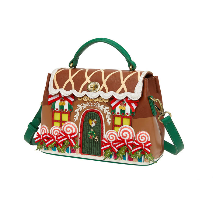 Gingerbread house-themed handbag with decorative elements on a white background