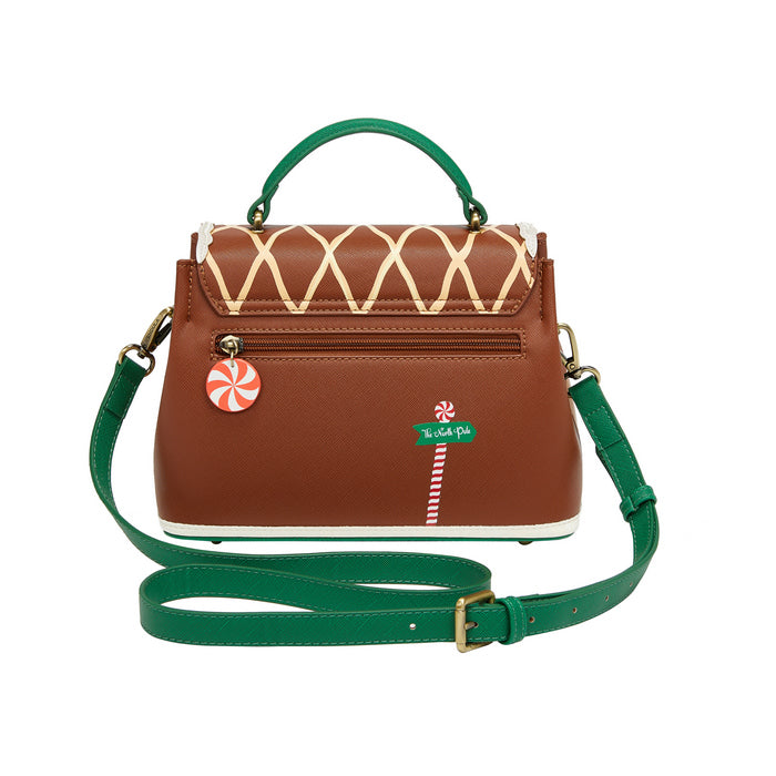 Brown handbag with green strap and festive design on a white background