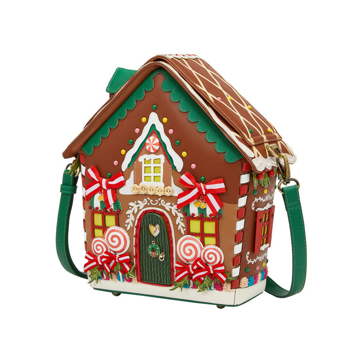Gingerbread house-shaped handbag with decorative elements on a white background