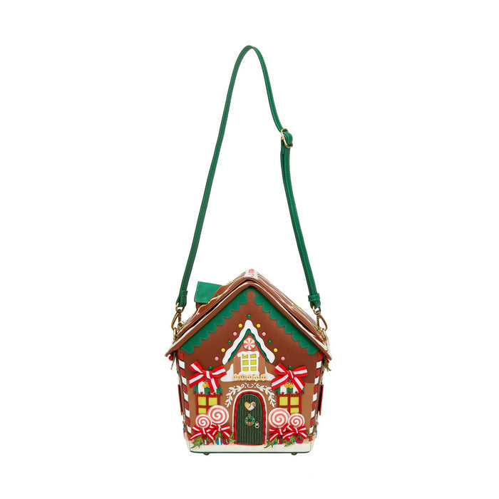 Gingerbread house-shaped handbag with a green strap on a white background