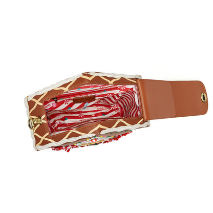 Giraffe-patterned umbrella with a brown handle on a white background