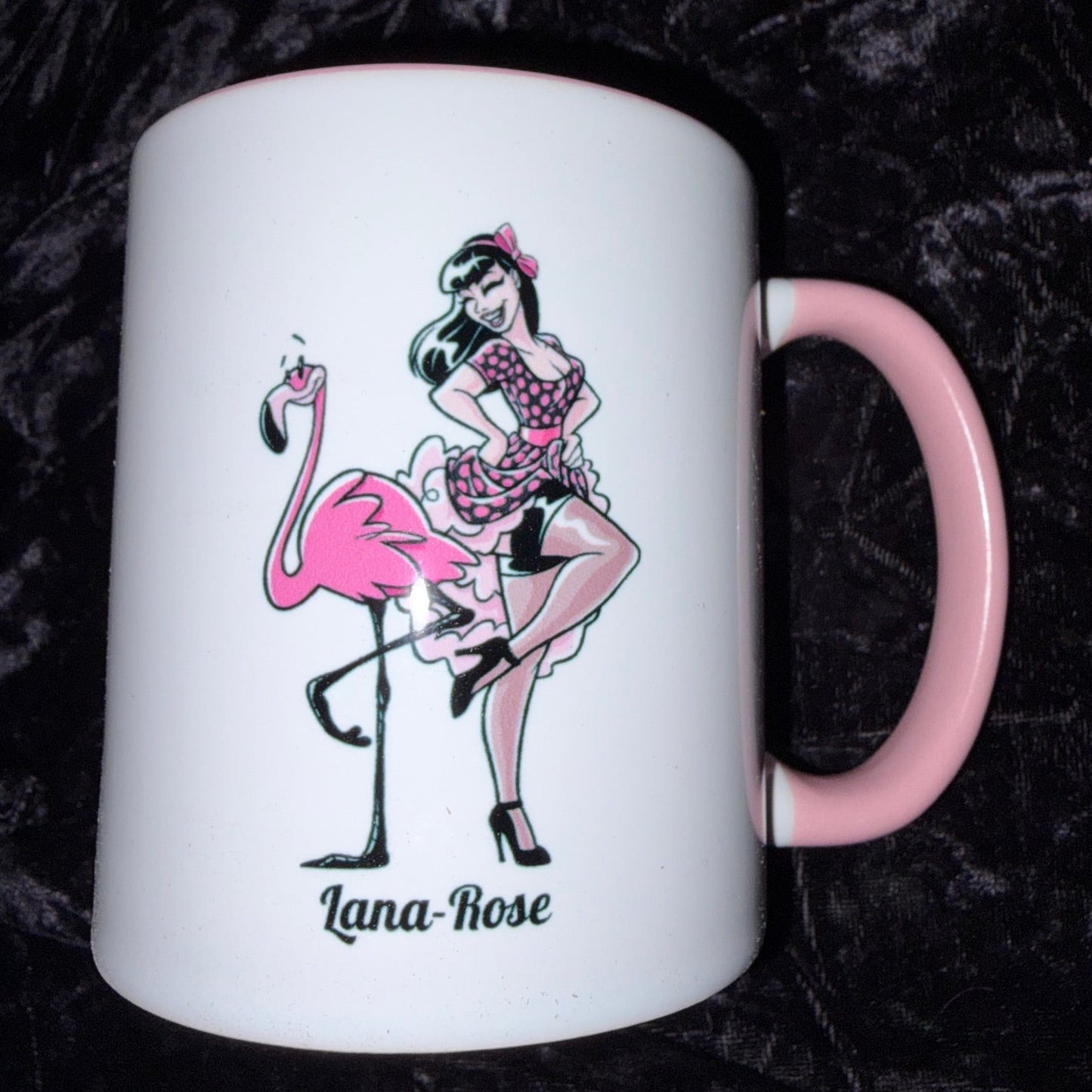 Mug with a design of a woman in a pink dress and flamingo on a black textured background