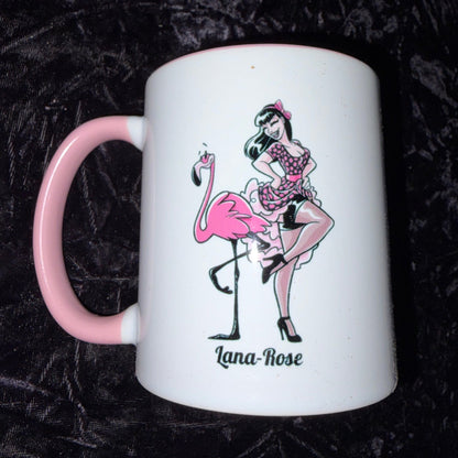 White mug with pink handle featuring a graphic design on a black textured background