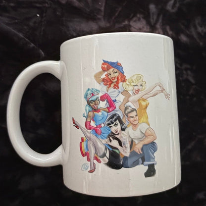 White mug with colorful character design on a dark textured background