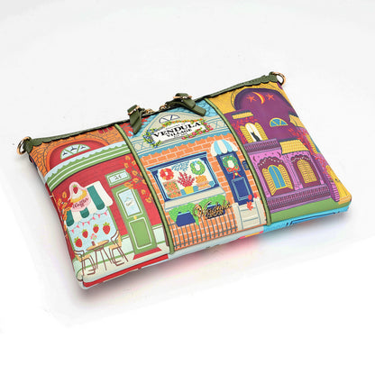 A colorful zippered clutch bag featuring a whimsical street-art style print with storefront illustrations in red, green, orange, yellow, blue, and purple. The bag has a gold-tone metal clasp closure and a small central label that reads 'VINTAIA'.
