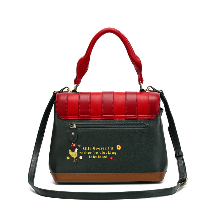 A structured handbag with a red top handle and top flap, a dark green body, a brown base trim, and a black shoulder strap. The front has a small pocket with a decorative keychain charm and embroidered text reading 'Silly Goose? I'd rather be clucking fabulous!' with a chicken illustration.