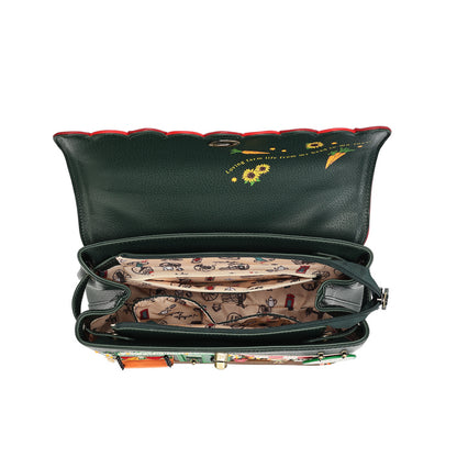 An open dark green leather shoulder bag with a patterned interior, featuring a red trim along the inner flap and a floral print on the exterior.