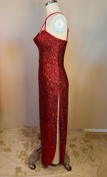 Red sequin dress on a mannequin against a plain background