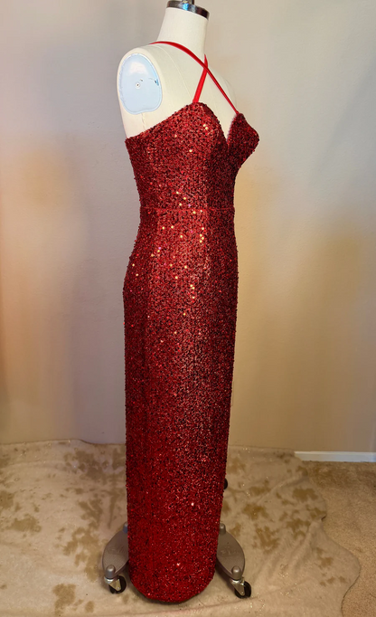 Red sequin dress on a mannequin against a plain background