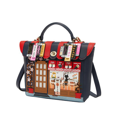 Handbag with a design of a street scene and various signs on a white background