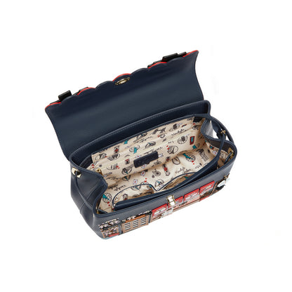 Blue handbag with a patterned interior on a white background