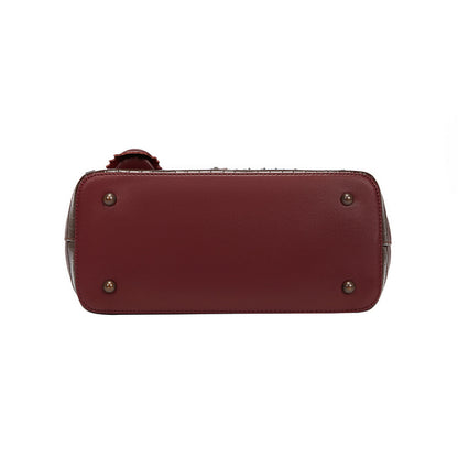 Maroon handbag with gold studs on a white background