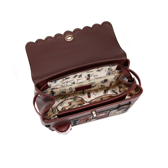 Brown handbag with patterned interior on a white background
