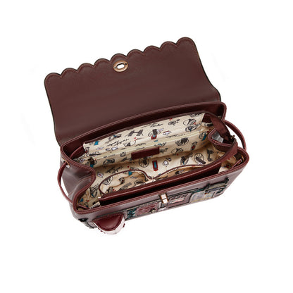 Brown handbag with patterned interior on a white background