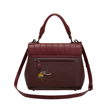 Maroon handbag with a visible brand logo on a white background
