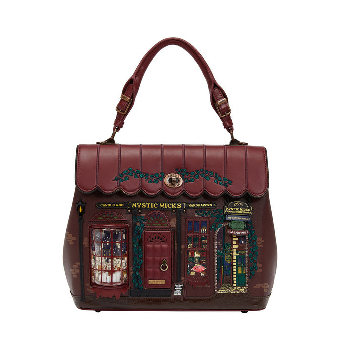 Brown handbag with detailed design resembling a store front on a white background