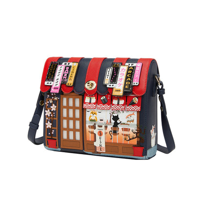 Handbag with a colorful design of a street scene and building facades on a white background