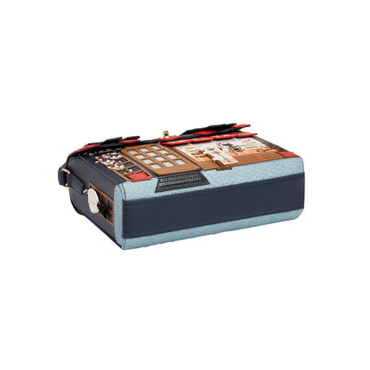 Blue and black suitcase with a patterned top on a white background