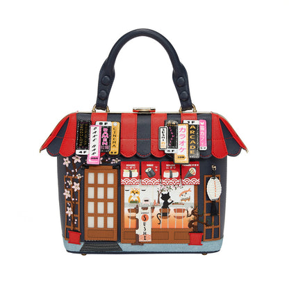 Handbag with a detailed design of a store front on a white background