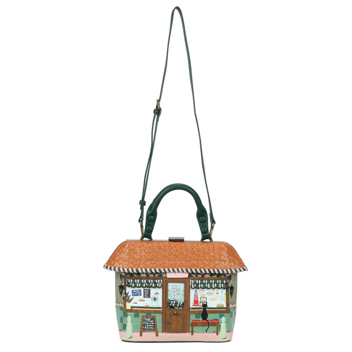 Handbag designed like a small building with a roof and windows on a white background