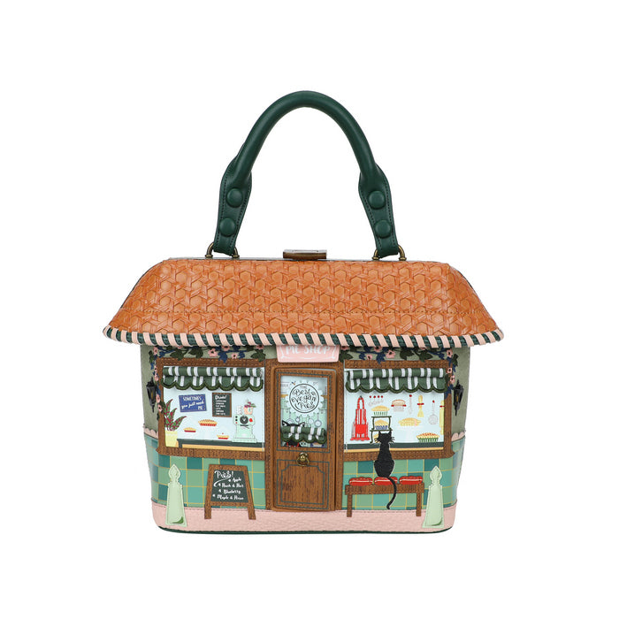 Handbag designed like a small cafe with a brown roof and green handle on a white background