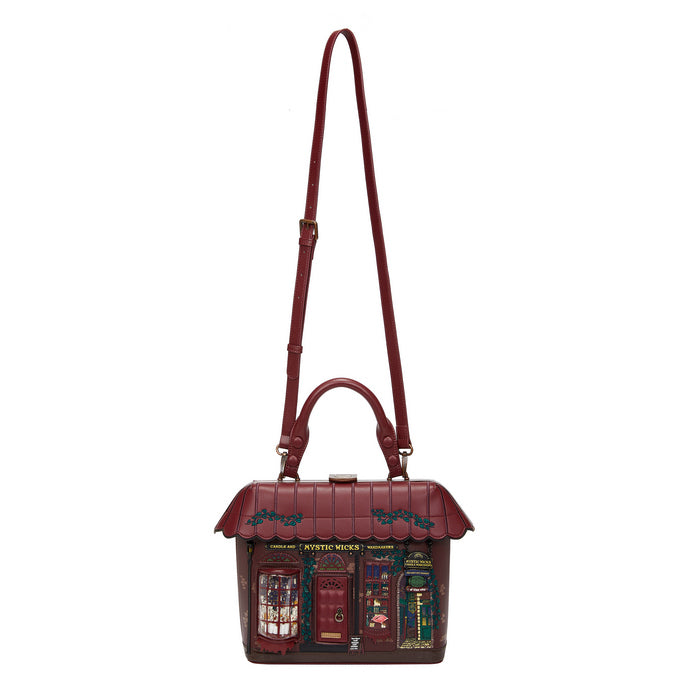 Bag designed like a small house with a red roof and decorative elements on a white background