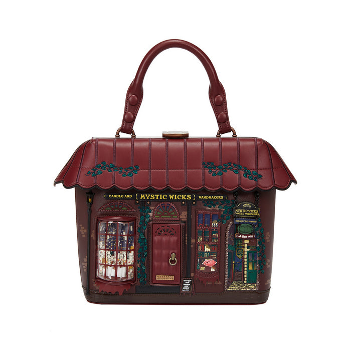 Handbag designed like a store facade with 'Mystic Wicks' branding on a white background