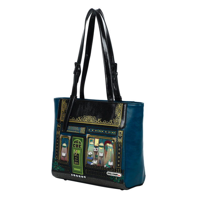 Blue handbag with decorative front panel on a white background
