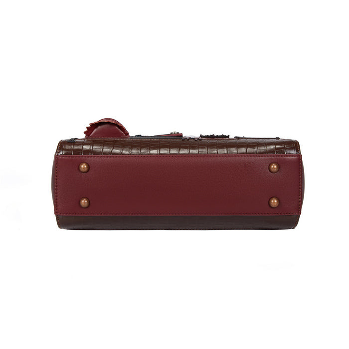 Brown leather bag with gold studs on a white background