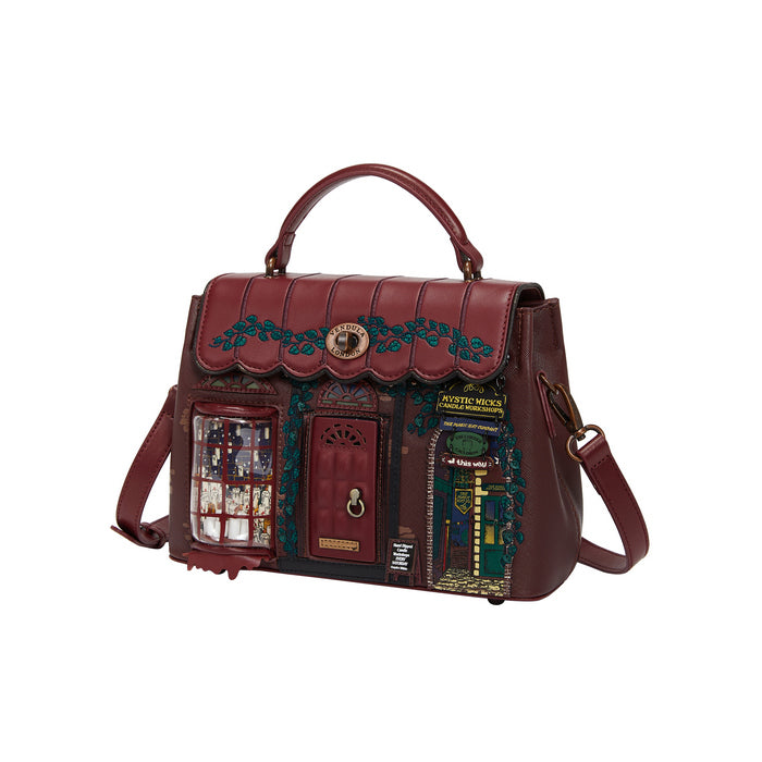 Brown leather bag with decorative elements on a white background