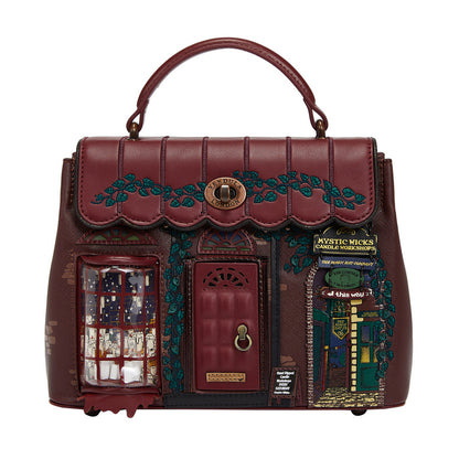 Decorative handbag with a house design and small door, featuring intricate details on a white background.
