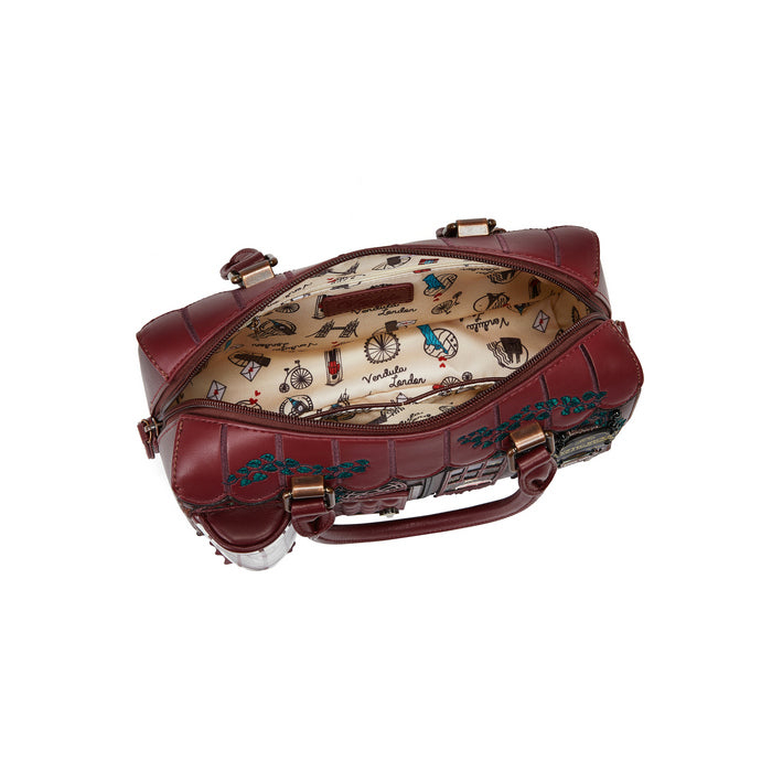 Brown leather bag with intricate design on a white background