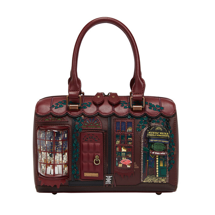 Decorative handbag designed like a small house with intricate details on a white background