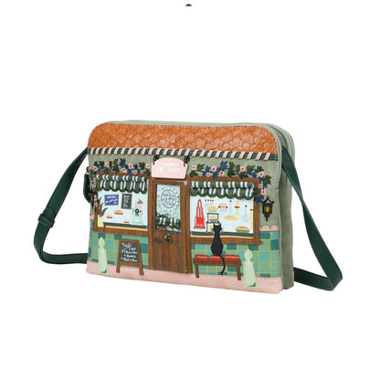 Handbag with a printed design of a cafe scene on a white background
