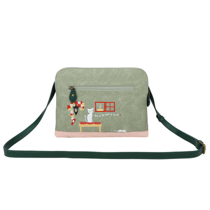 Green crossbody bag with cat-themed design on a white background