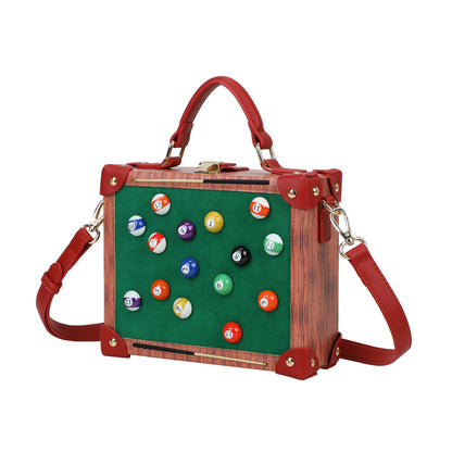 Handbag with pool ball design on a green background