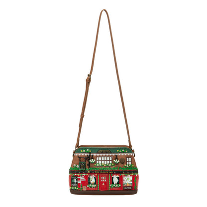 Handbag with a festive design featuring a house and teddy bear on a white background