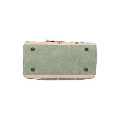 Green and pink handbag with gold accents on a white background