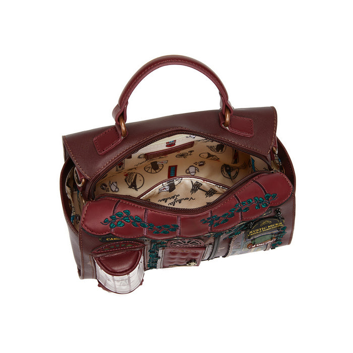 Brown handbag with decorative interior on a white background