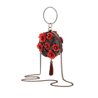 Round handbag with red floral design and chain strap on a white background